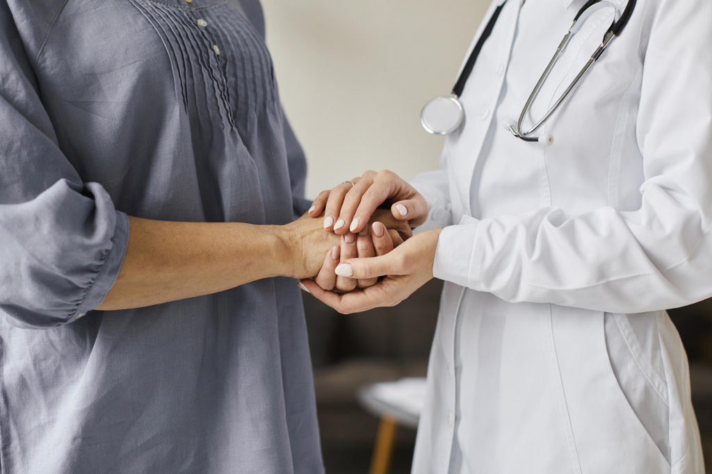 Doctor holding patient's hand. Rehabilitation and recovery from substance abuse. Complete Healthcare and Addition. A COMPREHENSIVE PROVIDER FOR SUBSTANCE ABUSE TREATMENT
